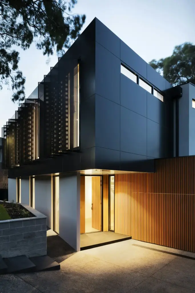 Modern home with lawn at dusk